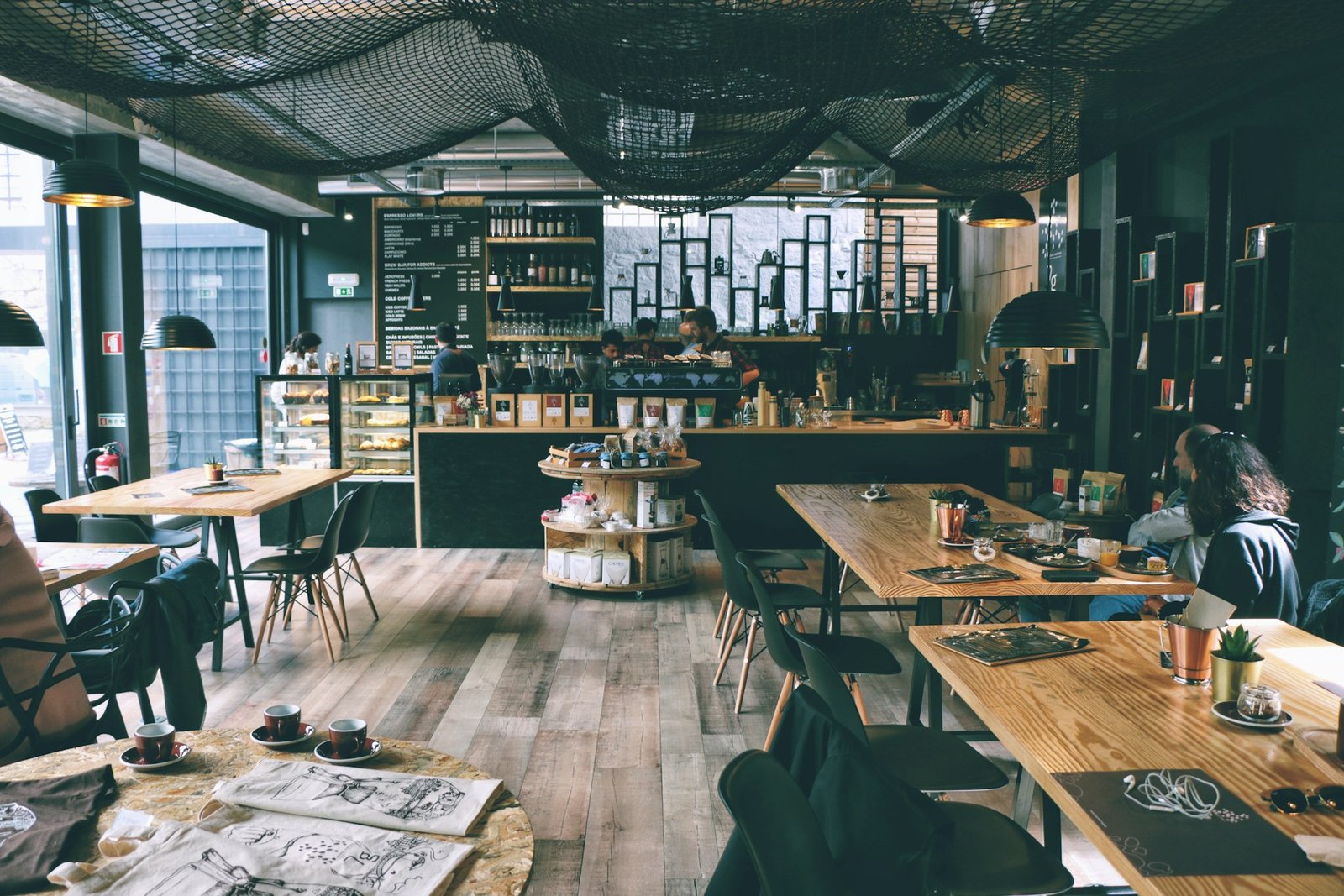 Cafe interior design with wooden tables and open shelving