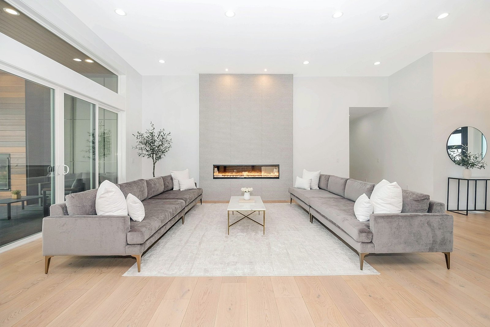 Drawing room interior design with velvet sofas and feature wall