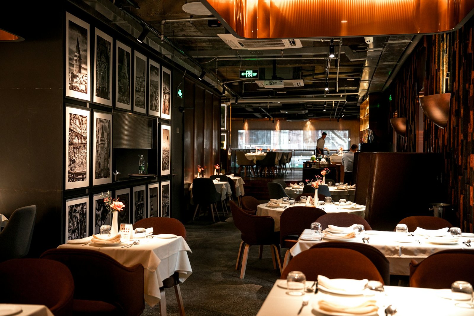 Hotel restaurant and fine dining area with art wall and table settings