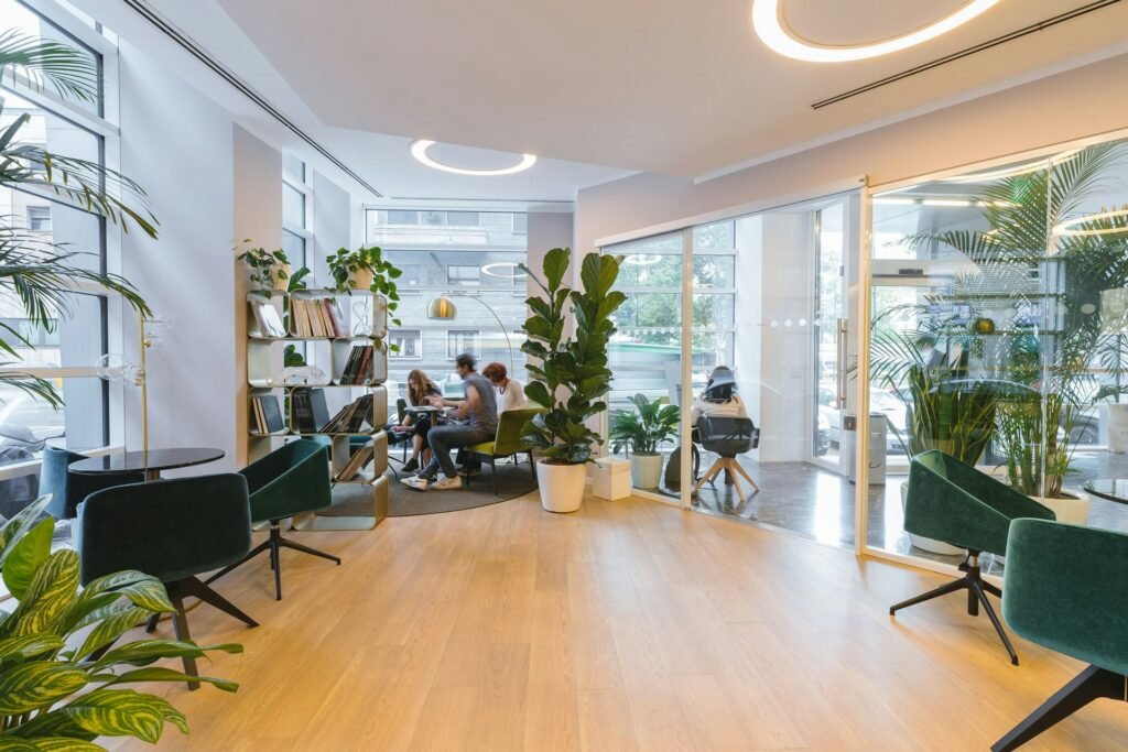 Illustrative modern office interior with lounge seating and glass-walled rooms