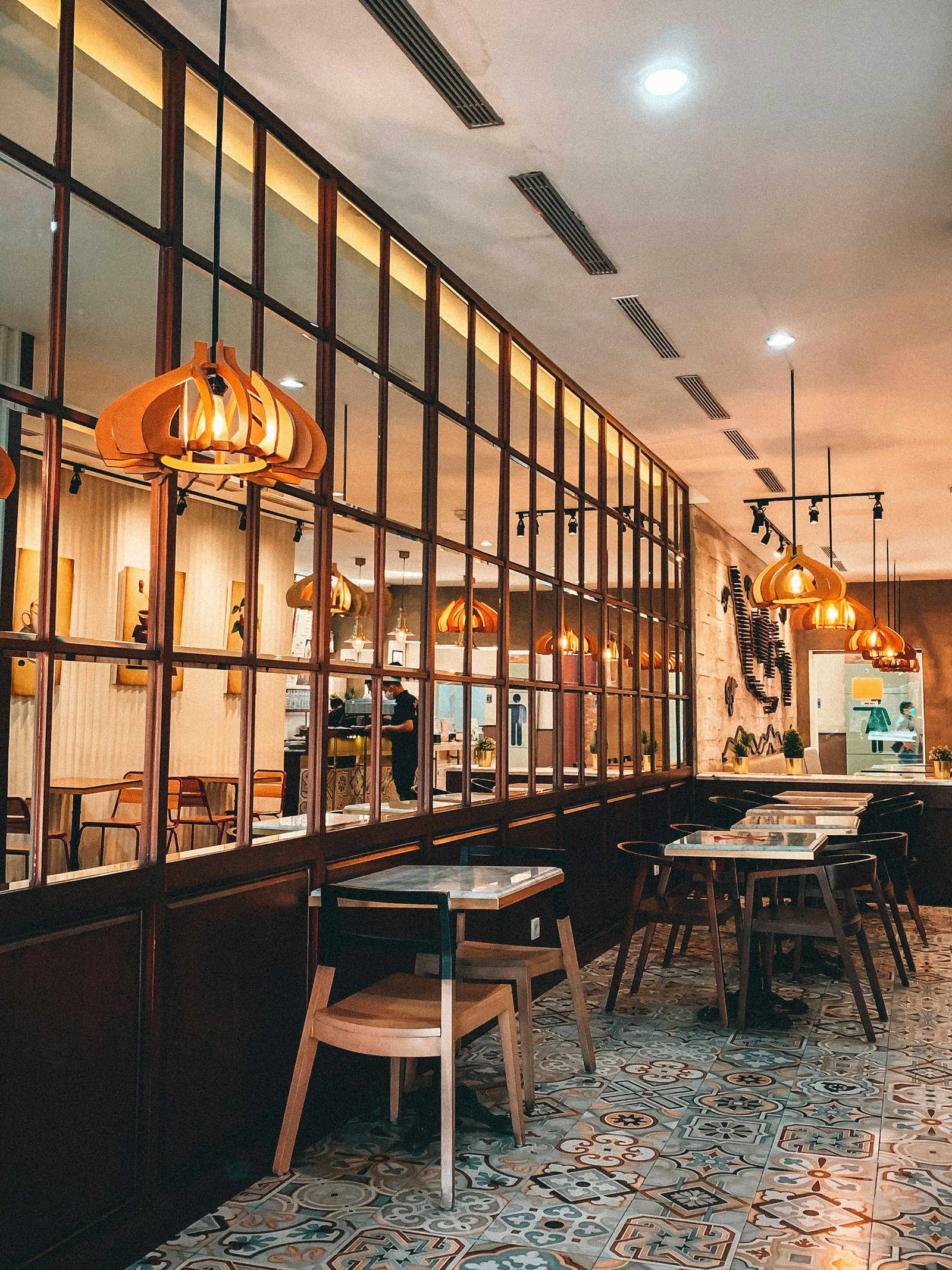 Restaurant seating layout with pendant lighting and glazed screen